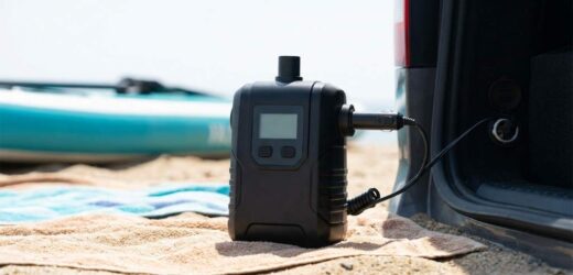 Niufazu electric paddle board pump troubleshooting beside an inflatable SUP