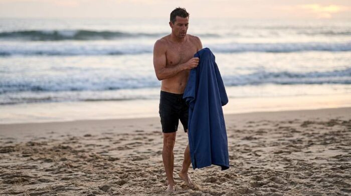 Sun Cube Surf Poncho hanging with hood and pocket fully open